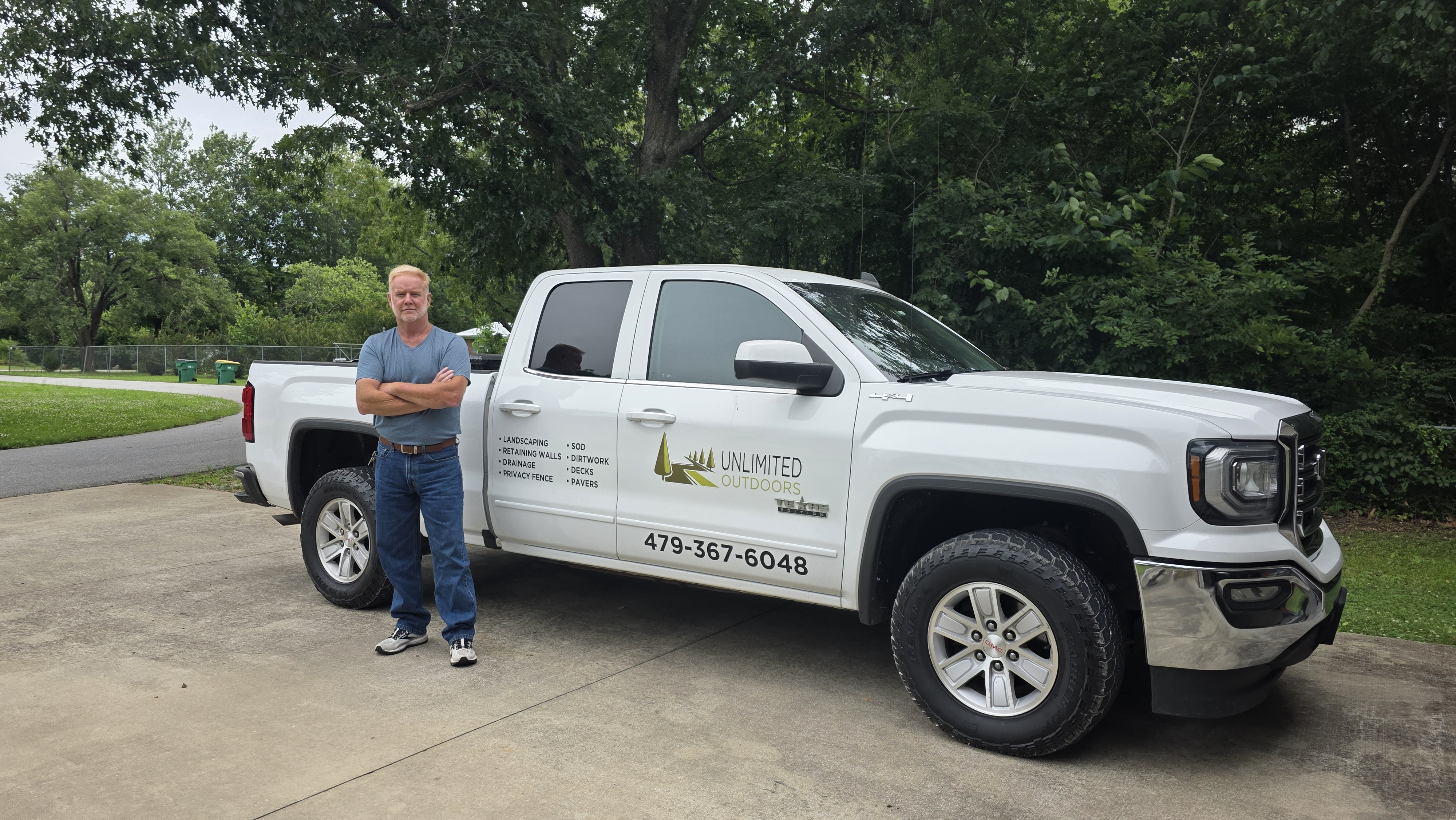 Richard Pigott, owner of Unlimited Outdoors, standing next to his work truck